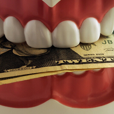 cash in a set of model teeth