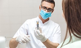 Wilton Manors implant dentist showing patient model dental implant