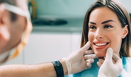 Woman having smile examined by cosmetic dentist in Wilton Manors, FL