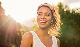 Woman outside smiling after cosmetic dentistry in Wilton Manors, FL