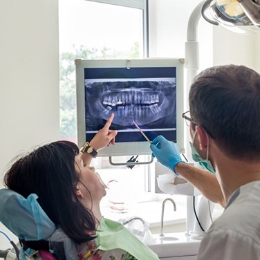 dentist showing a patient their dental X-rays 