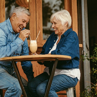 Senior couple sharing milkshake with dentures in Wilton Manors