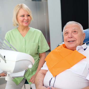Older man learning about dental services near Fort Lauderdale, FL.