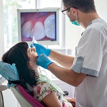 dentist using intraoral camera