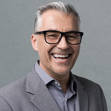 man smiling with glasses