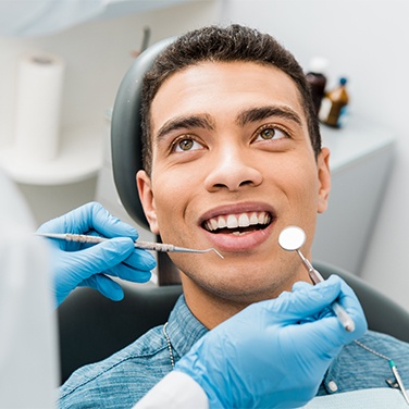 man getting a dental cleaning