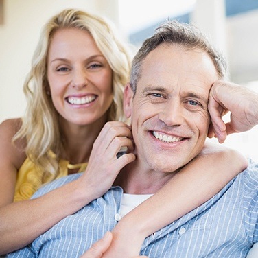 husband and wife smiling