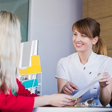 patient talking to front desk worker