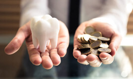 tooth balanced with a pile of coins