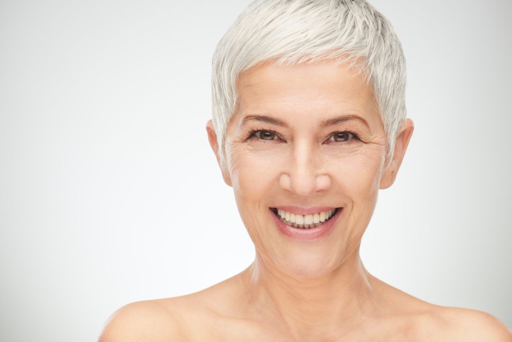 older woman smiling perfect teeth