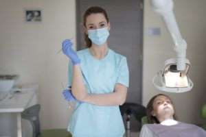 Dental hygienist and patient at dentist.