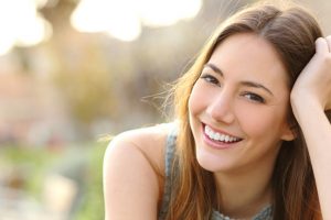 A patient smiling and showing off her healthy teeth.