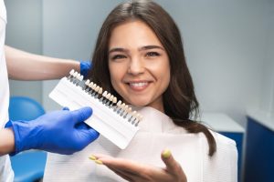 a woman getting veneers placed by her dentist