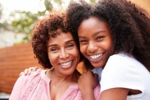 two generations of mothers with healthy and beautiful smiles