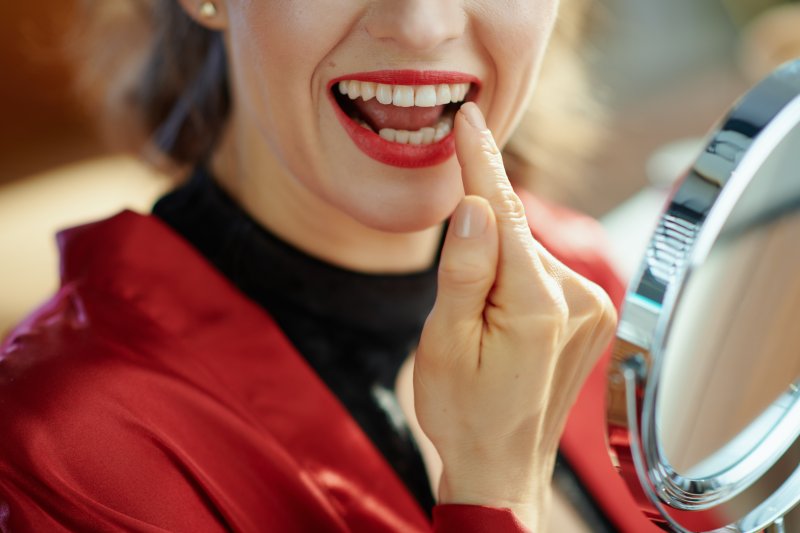 Woman checking their dental veneers for cavities